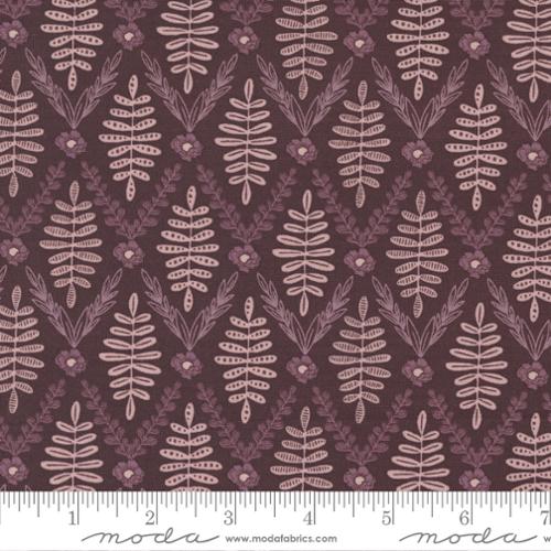 Fabric pattern with leaf design on a brown background, featuring Moda label.