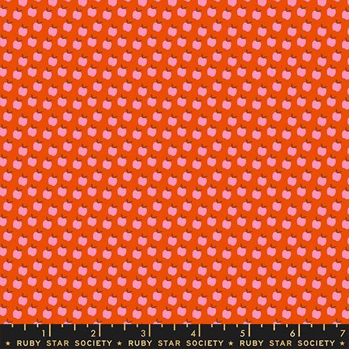 Fabric with pink apple pattern on orange background, labeled Ruby Star Society.