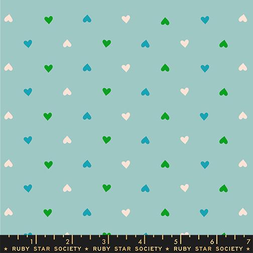Pattern of small hearts in green, blue, and white on a light blue background with Ruby Star Society label at the bottom.