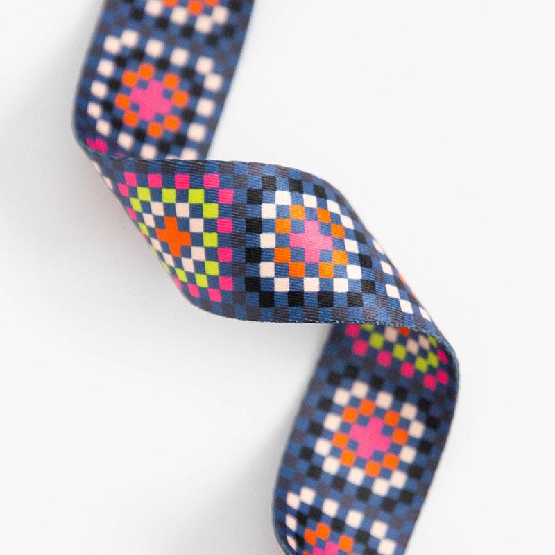 Granny square webbing in shades of blue, black, white, pink and green.