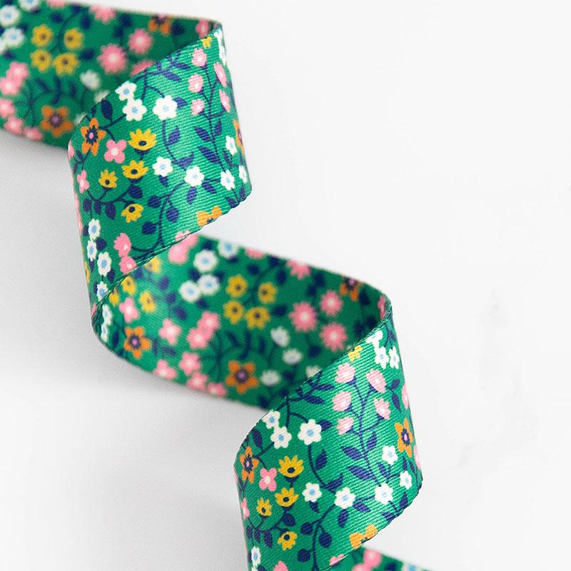 Green webbing with little flowers in white, pink and yellow.