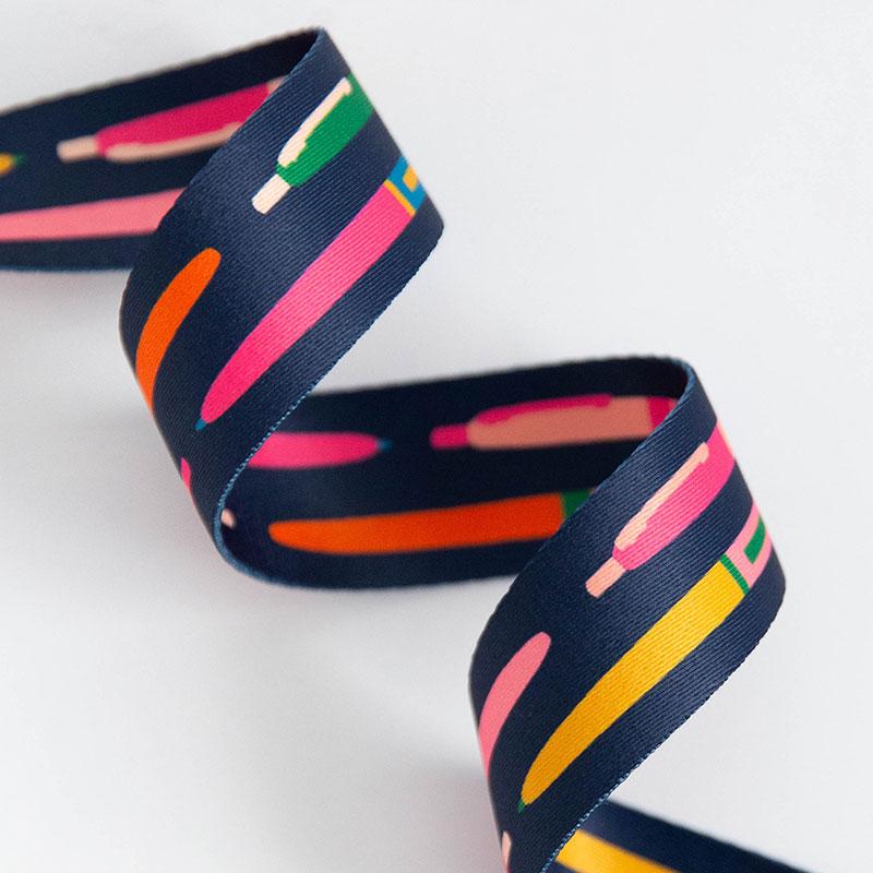 Navy webbing with red, yellow, pink and green pens.