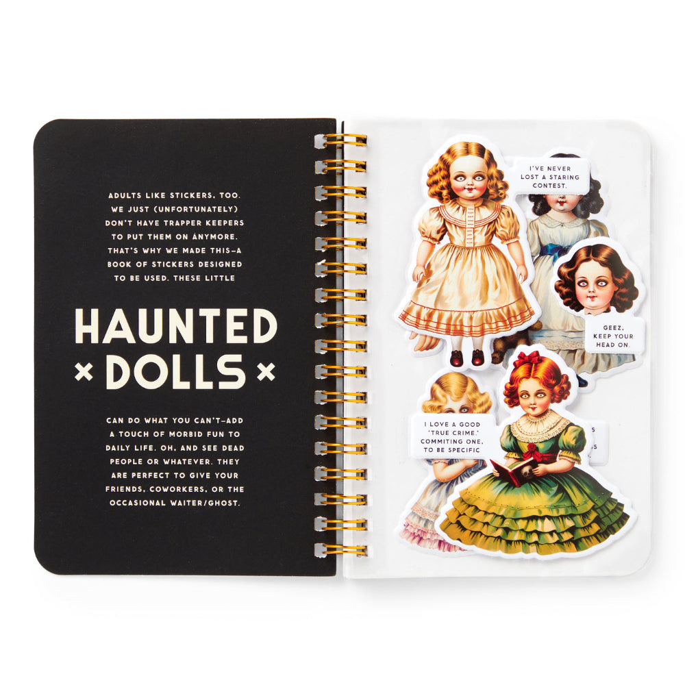 Notebook with 'Haunted Dolls' design on a white background