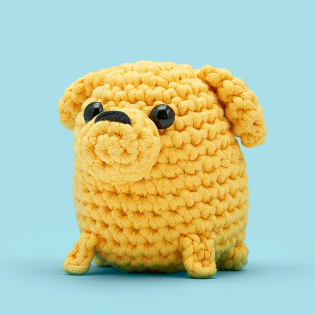 Diagonal view of a yellow crocheted dog