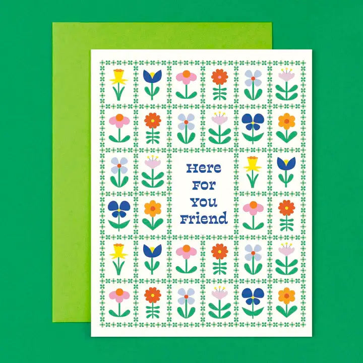 Greeting card with floral pattern and 'Here for you friend' text on a green background