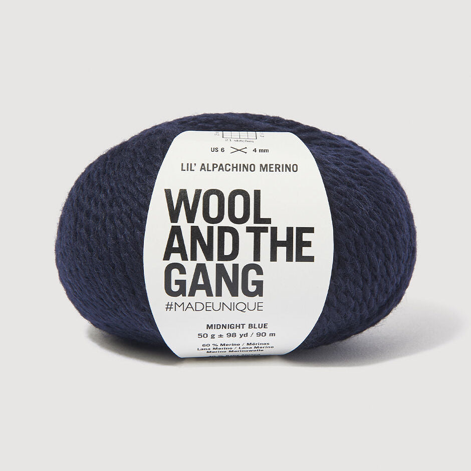 Navy skein of yarn with a 'Wool and the Gang' label on a light gray background