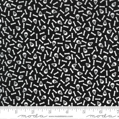 Black fabric with white skull and bone pattern, featuring a Moda label at the bottom.