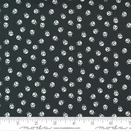 Black fabric with white skull pattern and Moda label