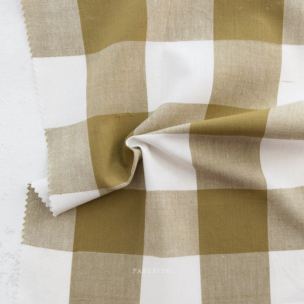 Checkered fabric with green and white squares on a white background