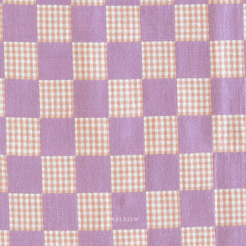 Checkered fabric pattern with purple and beige squares