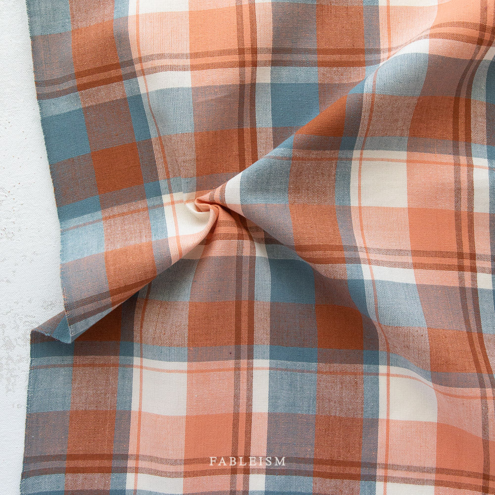 Plaid fabric with brown, blue, and beige colors on a white background, featuring the brand 'Fableism'.