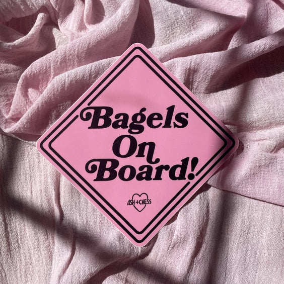 Pink bumper sticker with 'Bagels on Board'