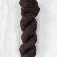 Brown skein of yarn on a white background