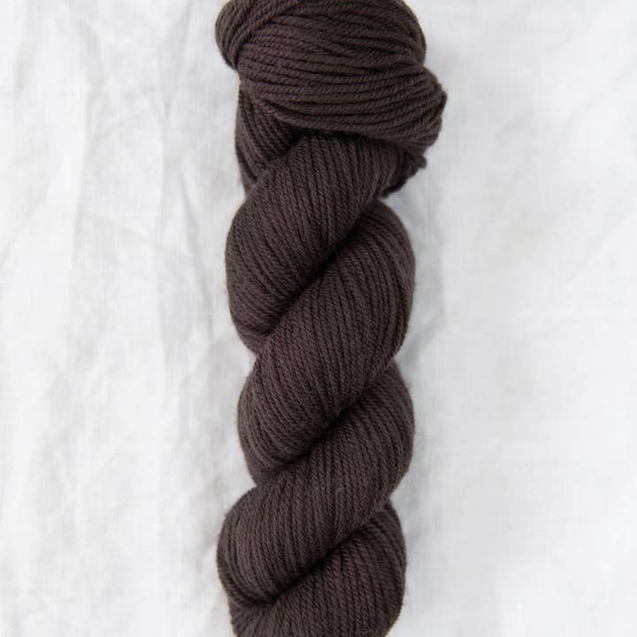 Brown skein of yarn on a white background