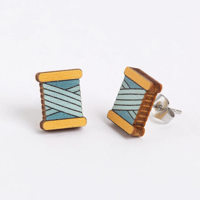 Wooden bobbin earrings on a white background