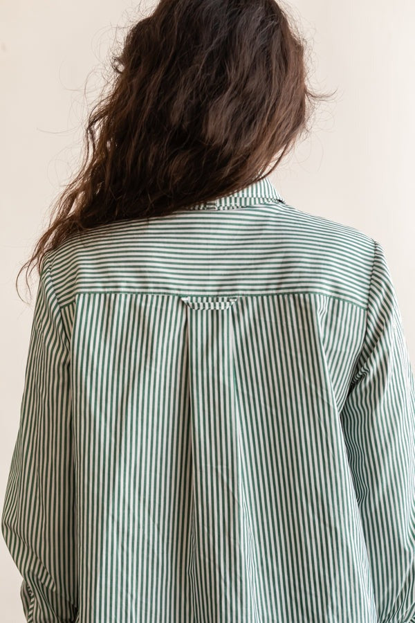 View from the back of a person wearing the long sleeve version of the Butano Button Up in a striped fabric.