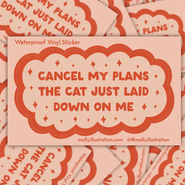 Vinyl sticker with text 'Cancel my plans the cat just laid down on me' on a patterned background