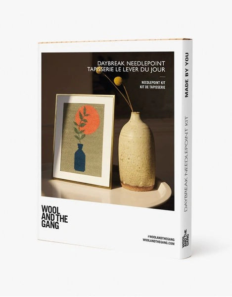 Wool and the Gang needlepoint kit packaging with a framed artwork and vase on a white background