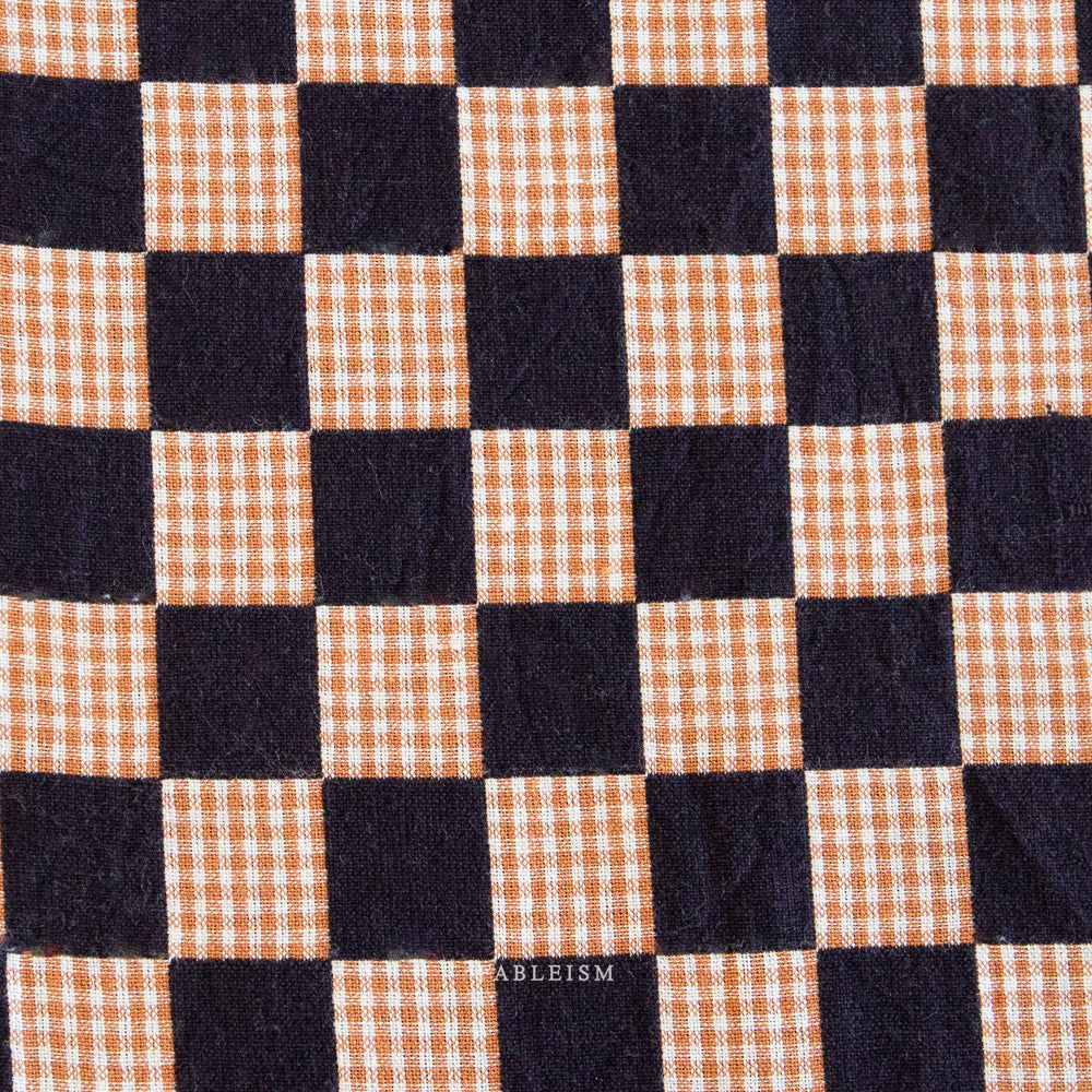 Checkered fabric with black and orange squares,