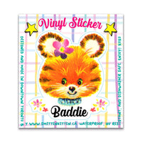 Vinyl sticker of a colorful tiger face with 'Baddie' text on a plaid background