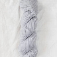 Light blue skein of yarn on a white background