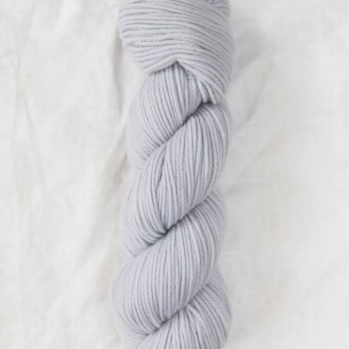 Light blue skein of yarn on a white background
