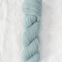 Light blue skein of yarn on a white background