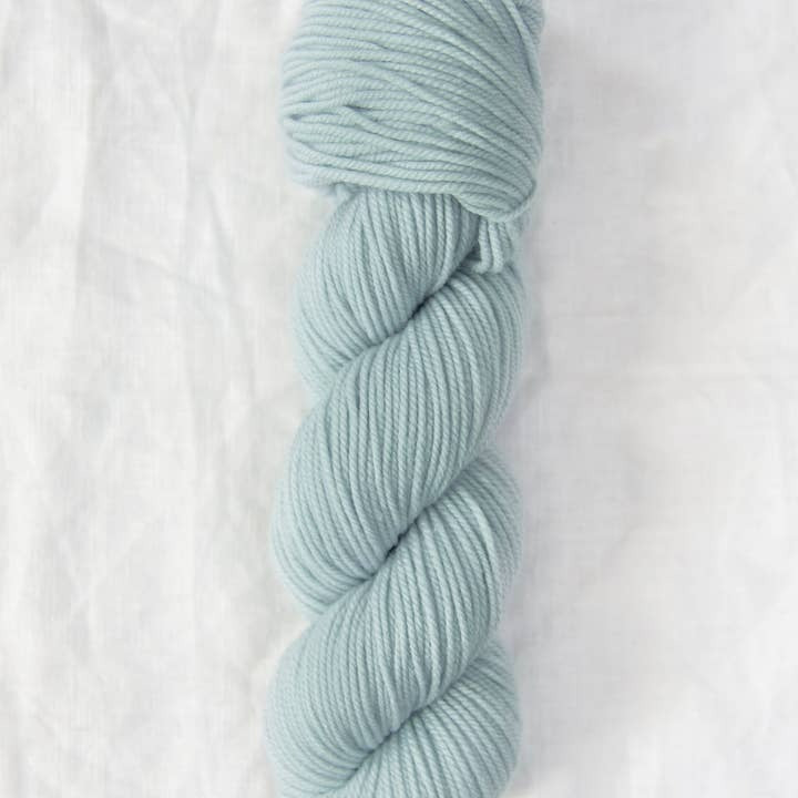 Light blue skein of yarn on a white background