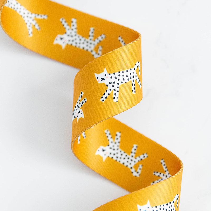 Orange webbing with white and black speckled snow leopards