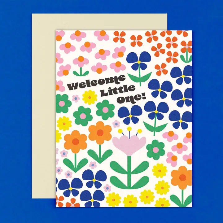 Greeting card with floral design and 'Welcome Little One!' text on a blue background