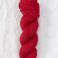 Red skein of yarn on a white background