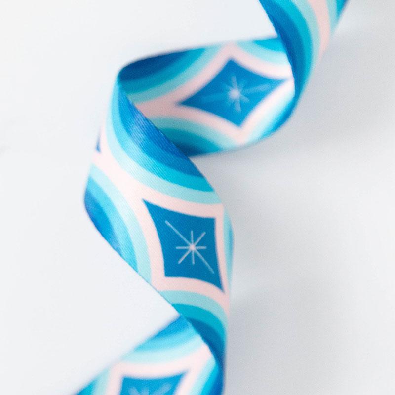 Teal webbing with pink and blue geometrics