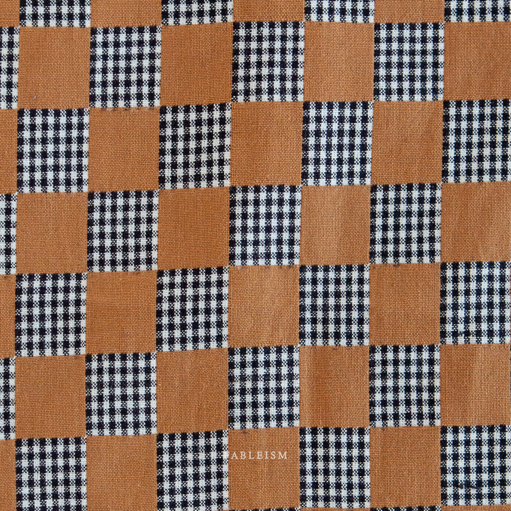 Checkered pattern with brown and black squares,