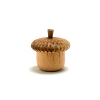 Wooden acorn-shaped container on a white background