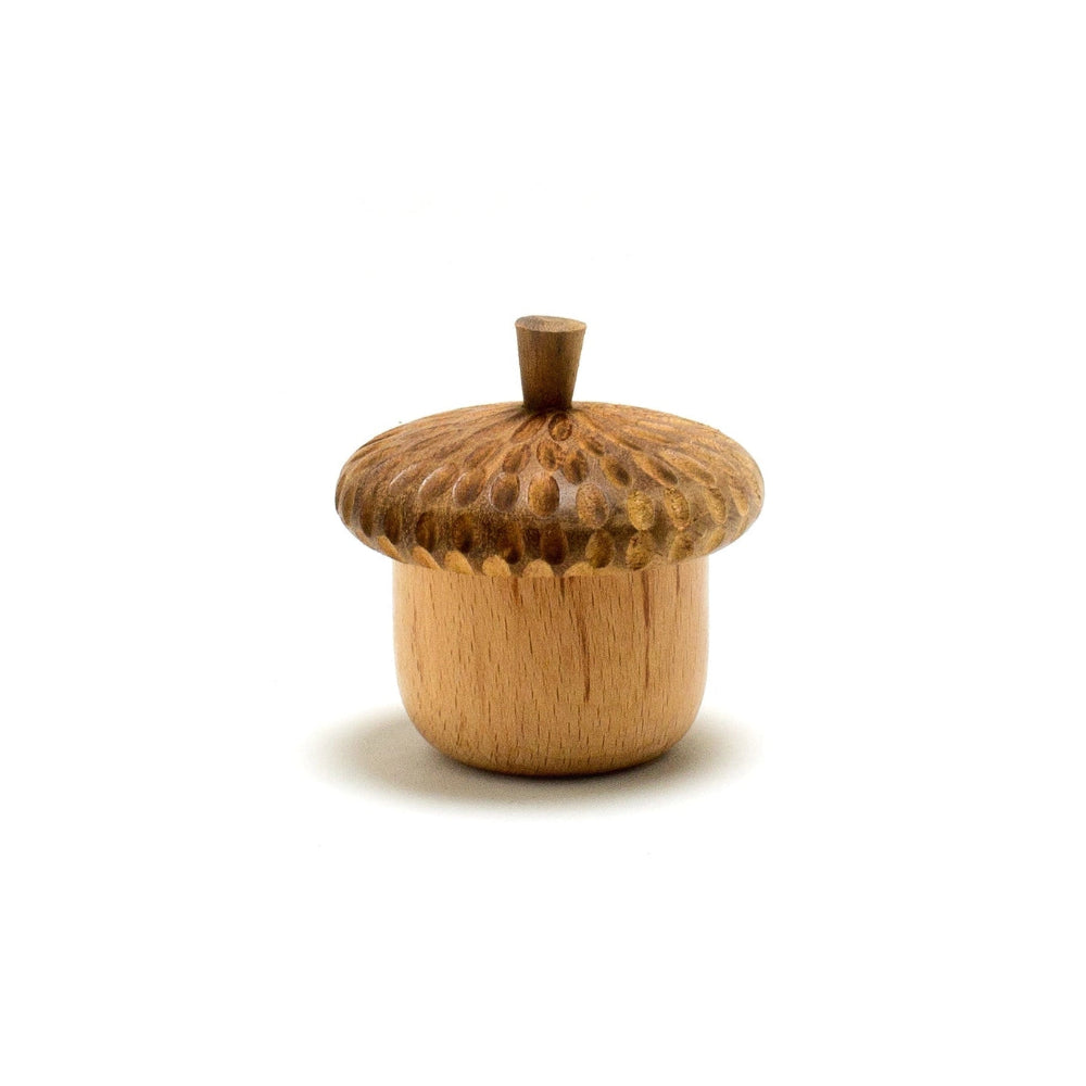 Wooden acorn-shaped container on a white background