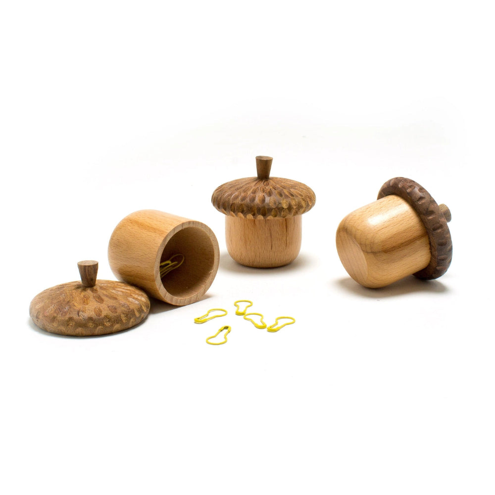 Wooden acorn-shaped containers with a white background