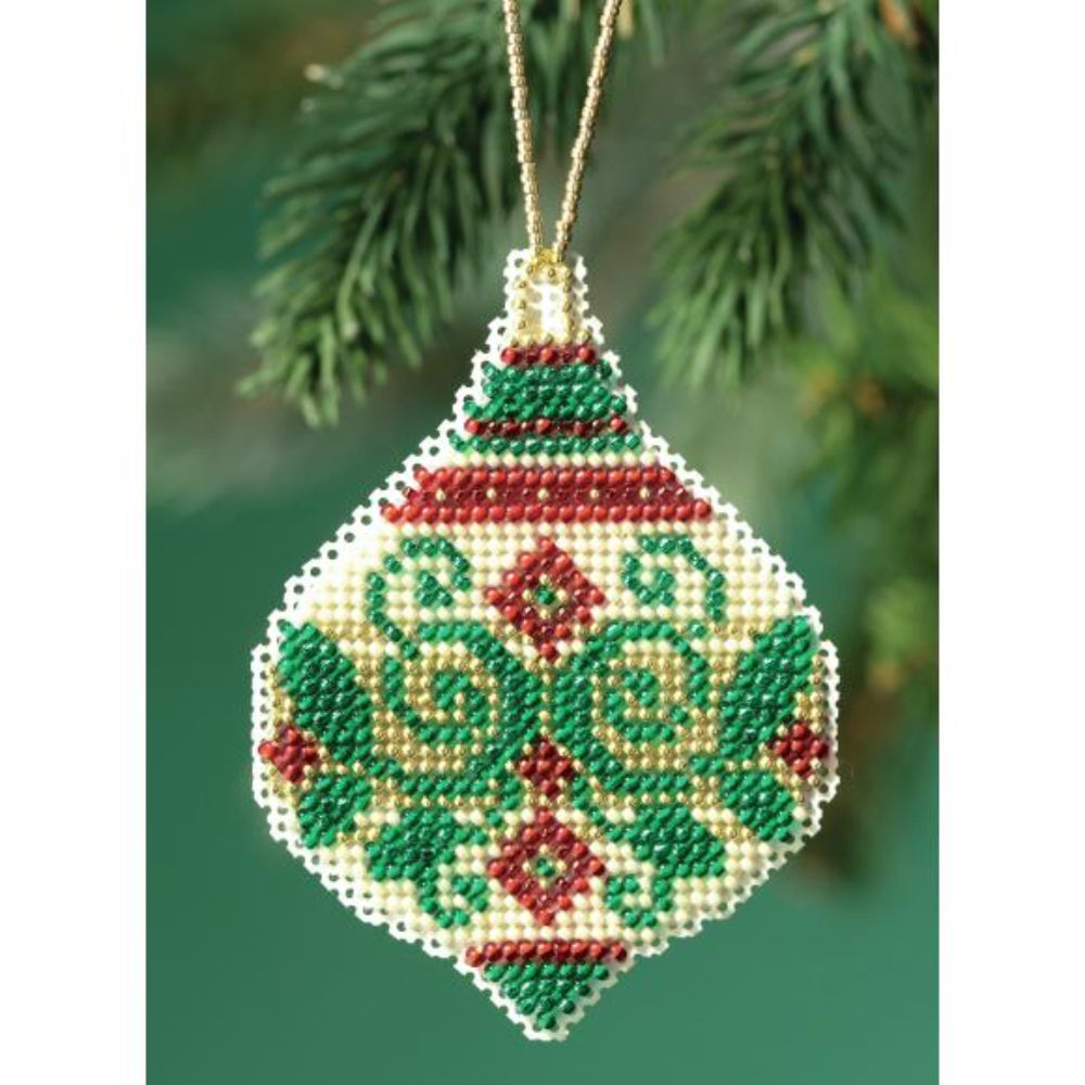 Decorative cross stitch Christmas ornament with beadwork on a green background