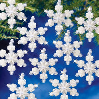 Beaded snowflake ornaments on a blue and green background