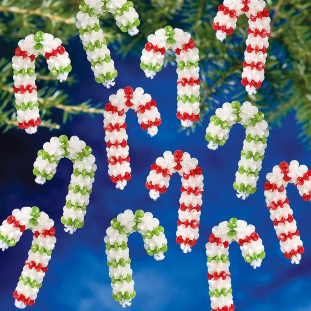 Beaded candy cane ornaments on a blue background with greenery