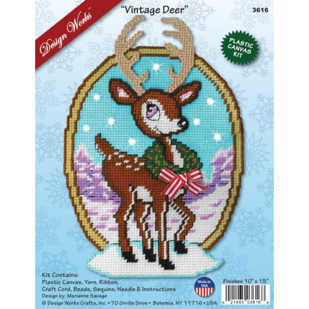 Needlepoint kit packaging featuring a deer with a wreath on a snowy background