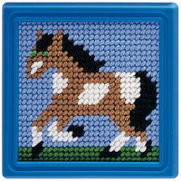 Needlepoint horse design on a blue fabric background