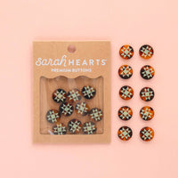 Packaged set of 'Sarah Hearts' premium buttons on a pink background