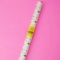 Roll of wallpaper with a pattern on a pink background