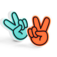 Two peace sign needle protectors, one blue and one orange, on a white background.