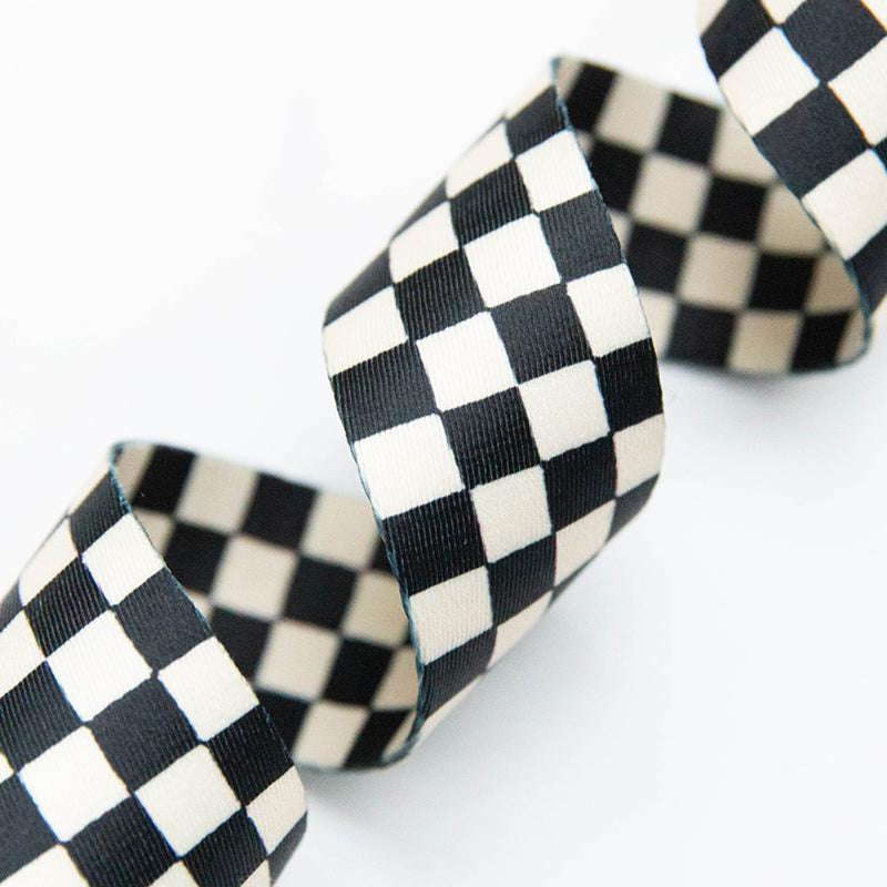Black and white checkered webbing on a white background