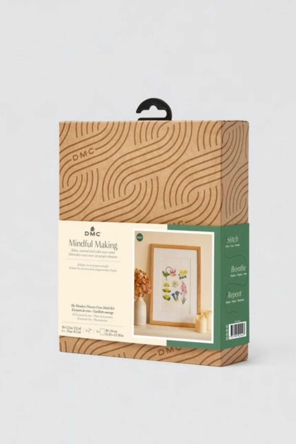 Packaging of a cross-stitch kit with a wooden frame design on a white background