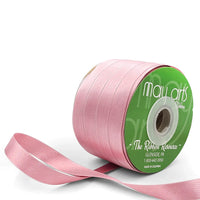 Pink ribbon spool with visible brand name on a white background