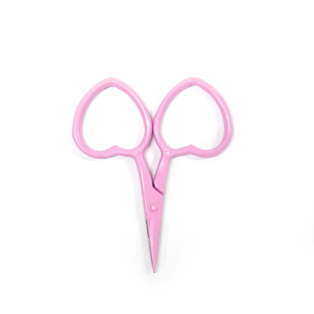 Pink embroidery scissors with heart-shaped handles on a white background