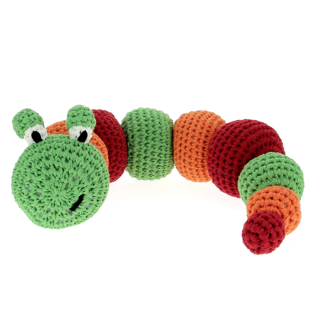 Crocheted toy caterpillar with green, orange, and red segments on a white background