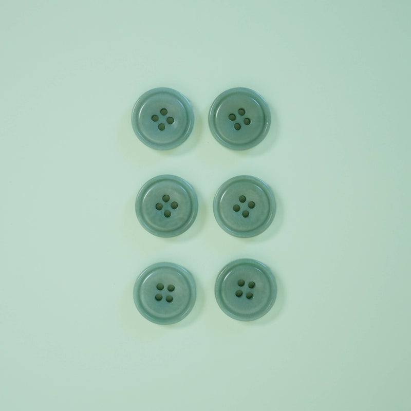 Five light blue buttons on a matching light blue background